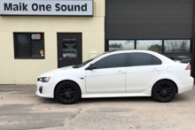 White 2015 Mitsubishi Lancer with dark window tint
